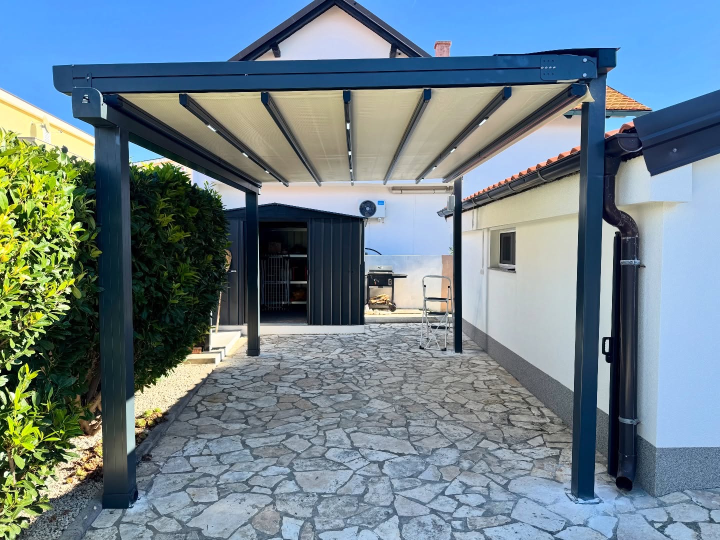 Perspective view of pergola awning covering residential garden — motorized fabric system, Turkey export
