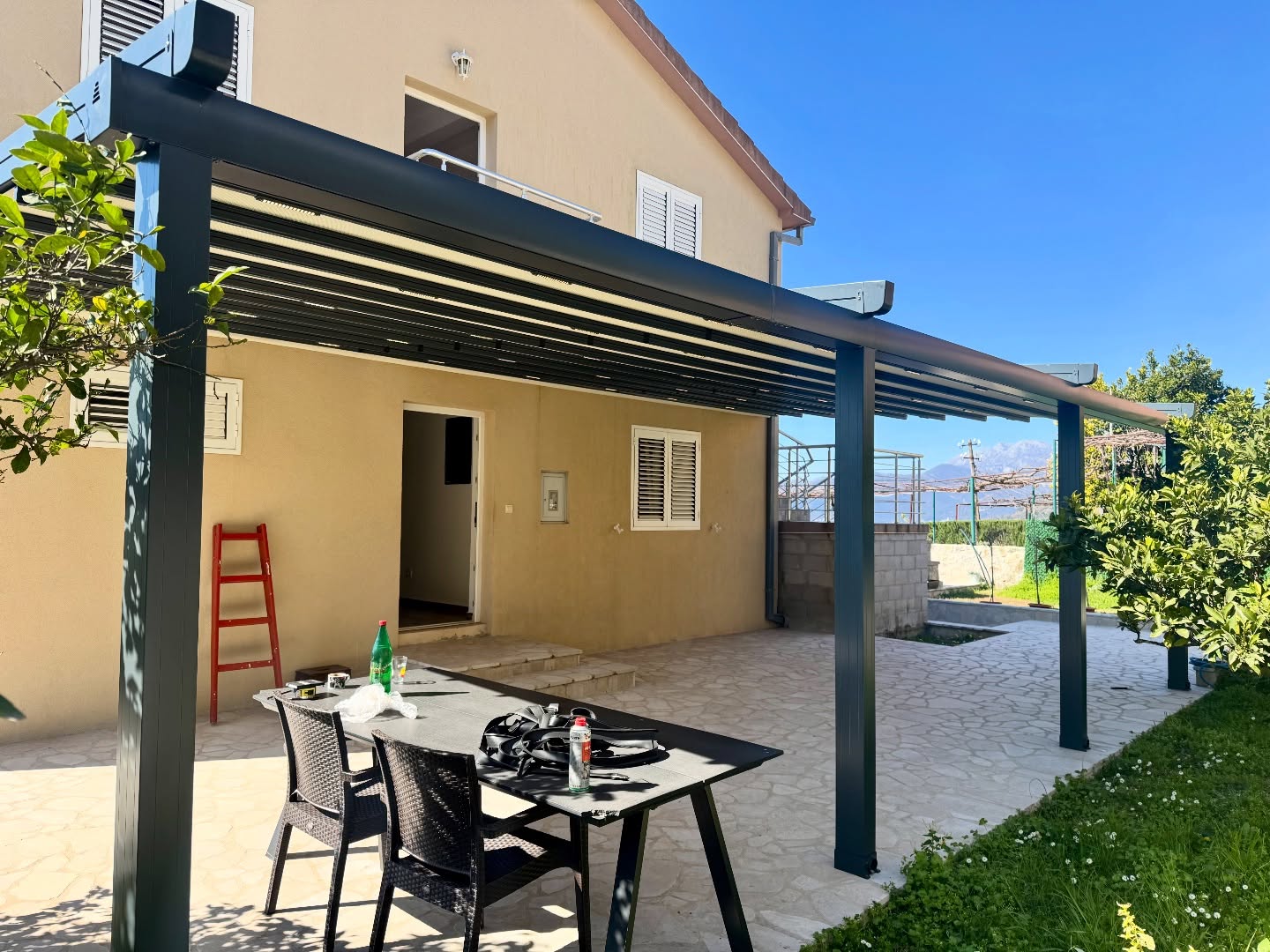Completed pergola awning installation on residential terrace — anthracite aluminum structure, Turkey