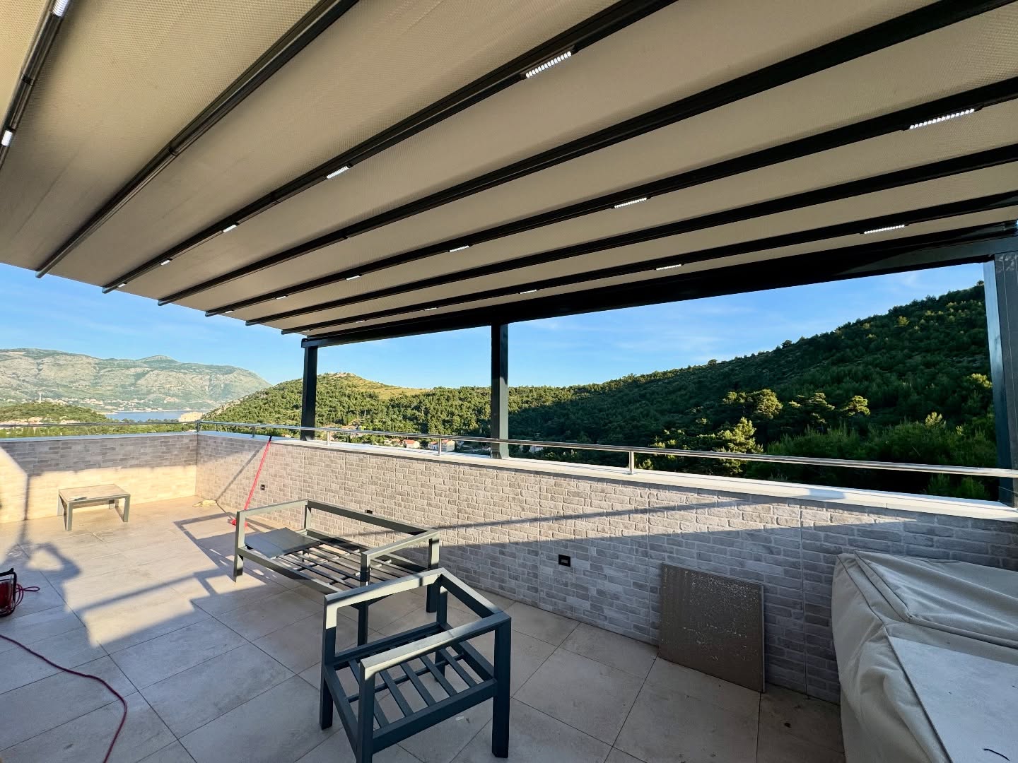 Pergola awning on elevated terrace with sea and mountain view — anthracite aluminum Turkey